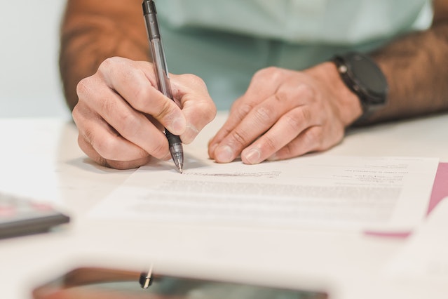 person signing a leasing document